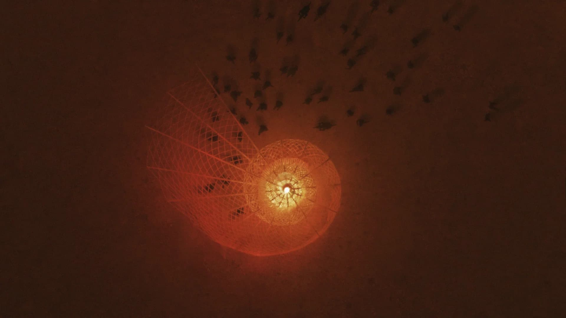 The Resonance Conch from above on the playa at night, its spiral glowing