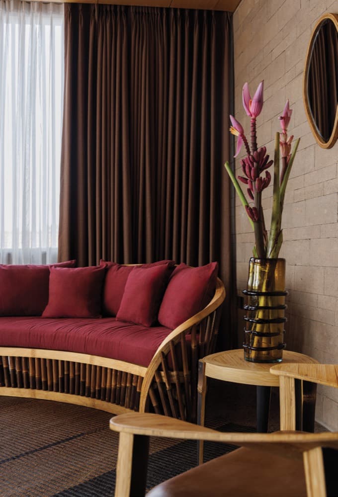 Living Moon Collection. Curved bamboo sofa in a warm interior