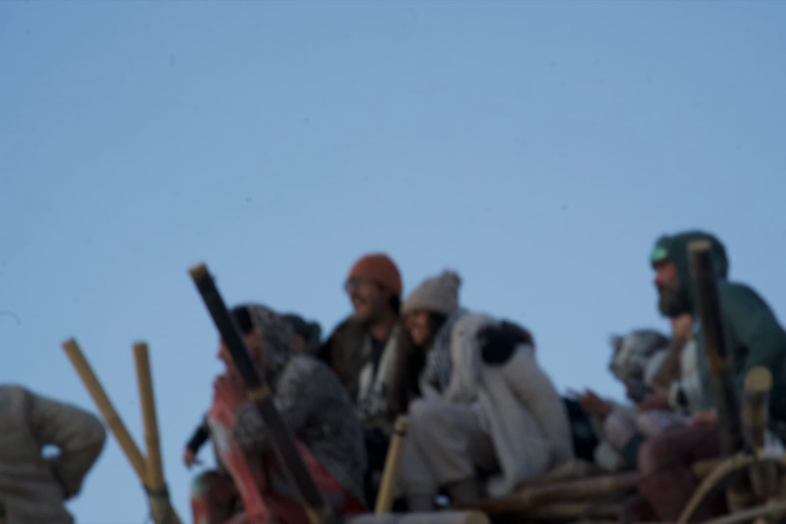 People wrapped in blankets on the summit of the Tree at dawn