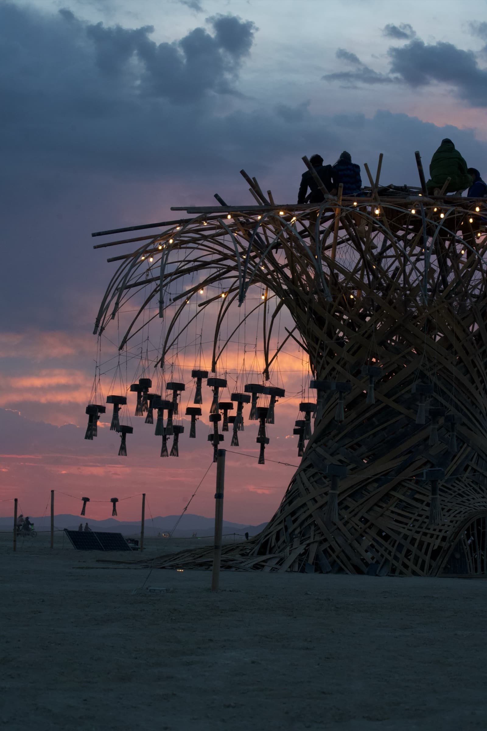 The completed Resonance Tree silhouetted against a pink and blue dusk sky