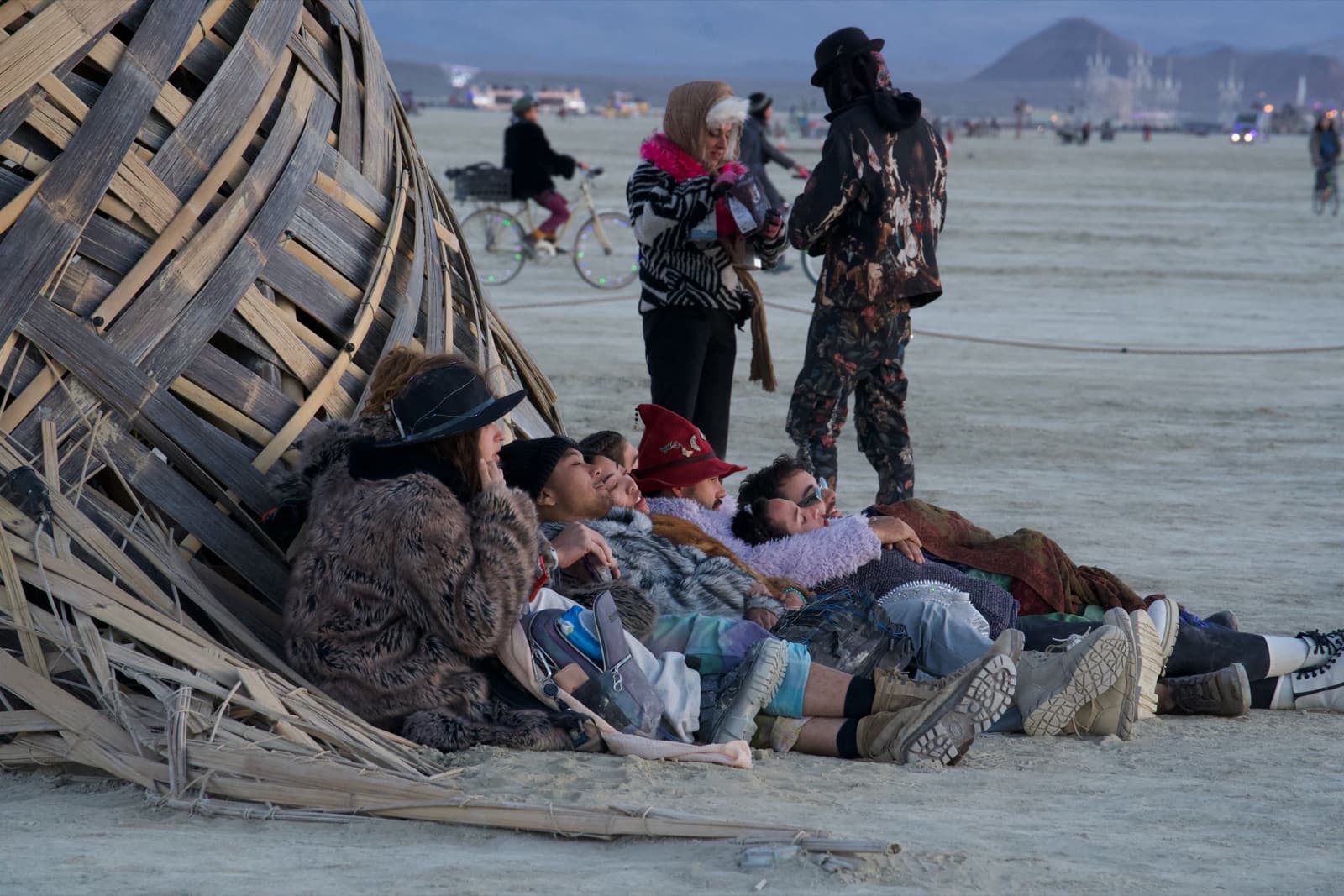 Half a dozen people settled into the woven base of the Tree, resting