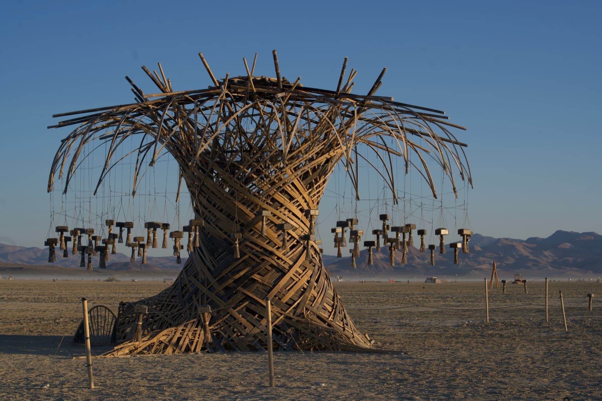 The Resonance Tree at first light on the open playa, lanterns still