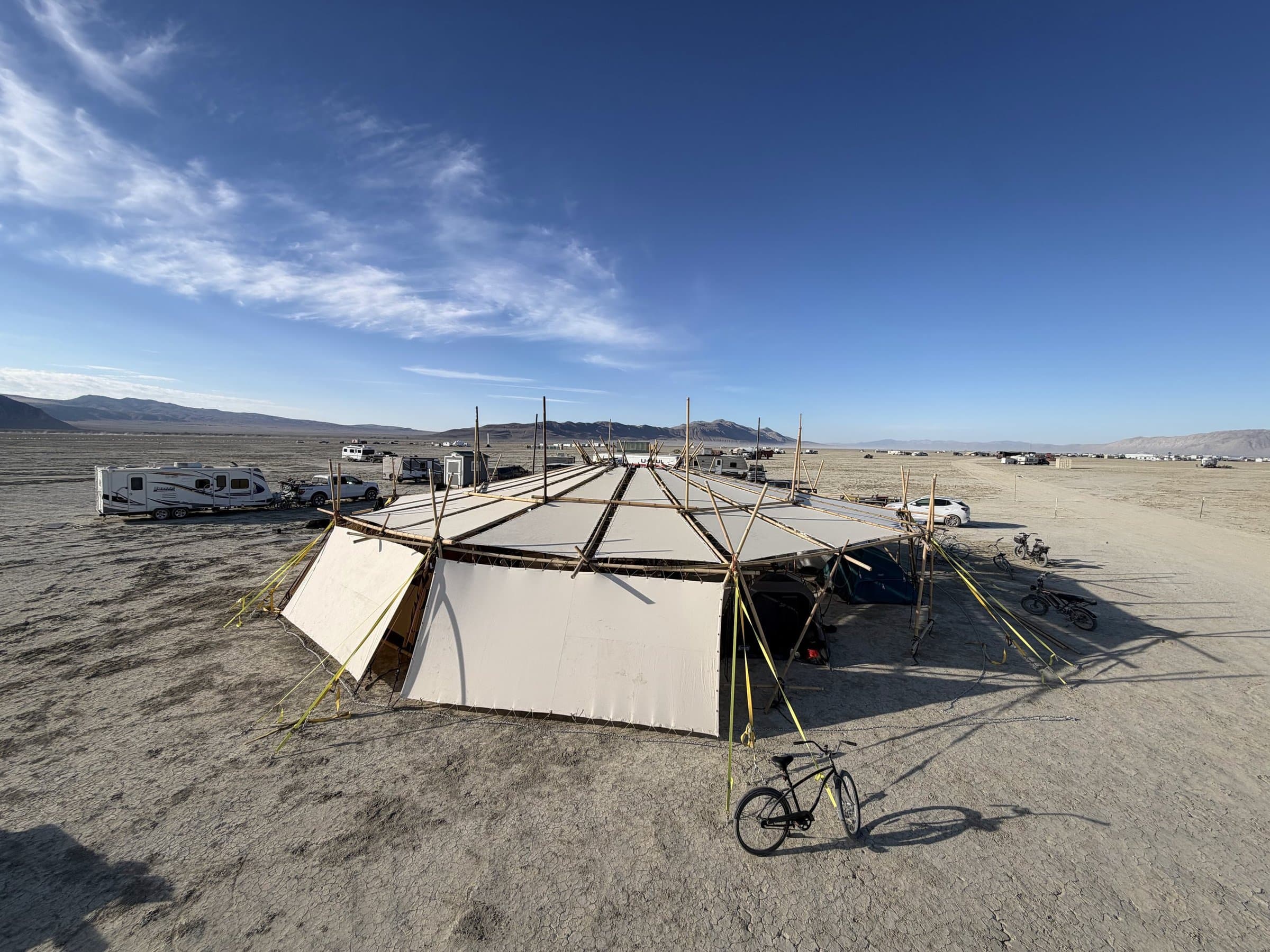 The Resonance Pavilion from up high: the whole white shade on its bamboo frame on the open playa